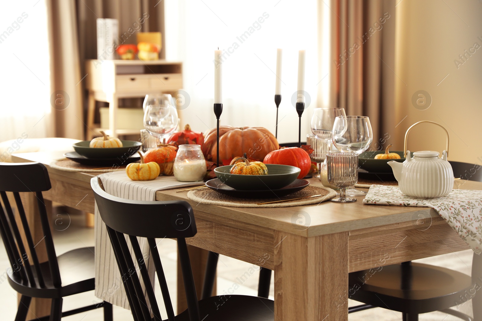 Photo of Stylish table setting with beautiful autumn decor in dining room