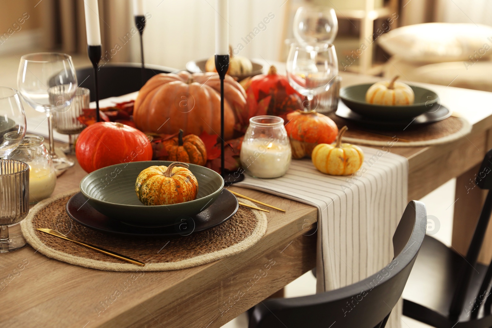 Photo of Stylish table setting with beautiful autumn decor in dining room