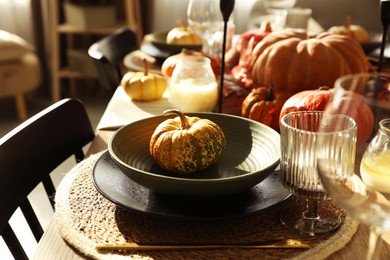 Photo of Stylish table setting with beautiful autumn decor in dining room