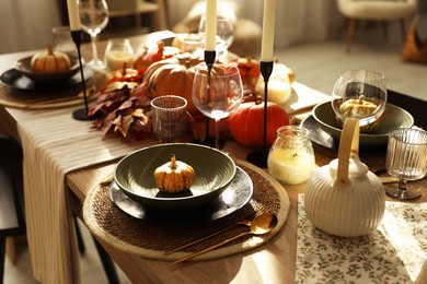 Photo of Stylish table setting with beautiful autumn decor in dining room