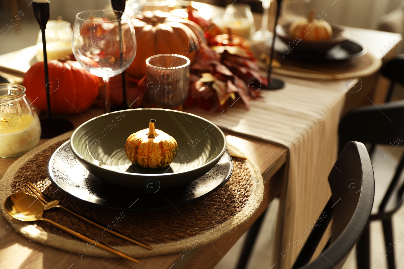 Photo of Stylish table setting with beautiful autumn decor in dining room