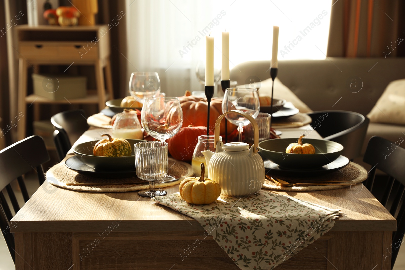 Photo of Stylish table setting with beautiful autumn decor in dining room