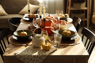 Photo of Stylish table setting with beautiful autumn decor in dining room