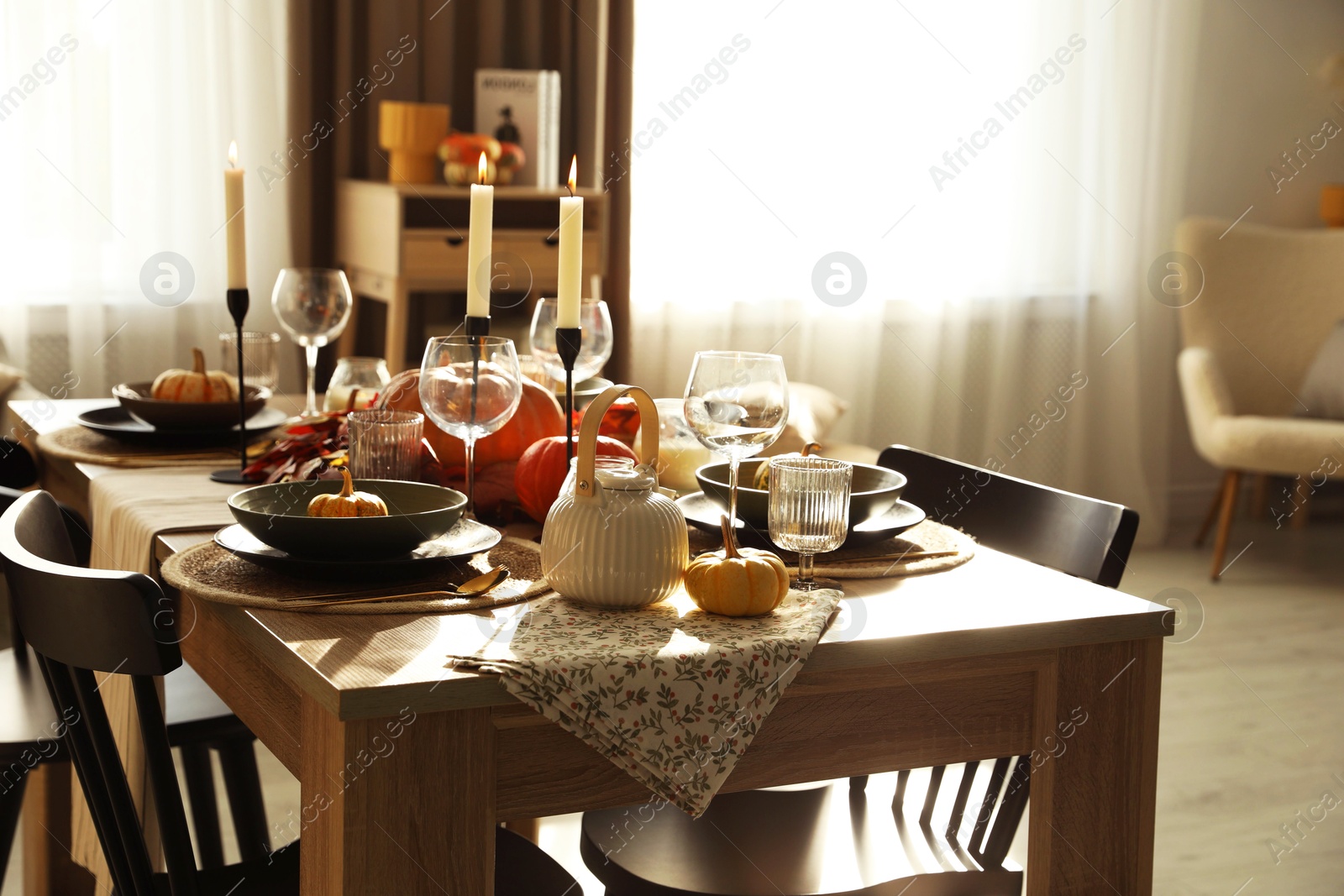 Photo of Stylish table setting with beautiful autumn decor in dining room