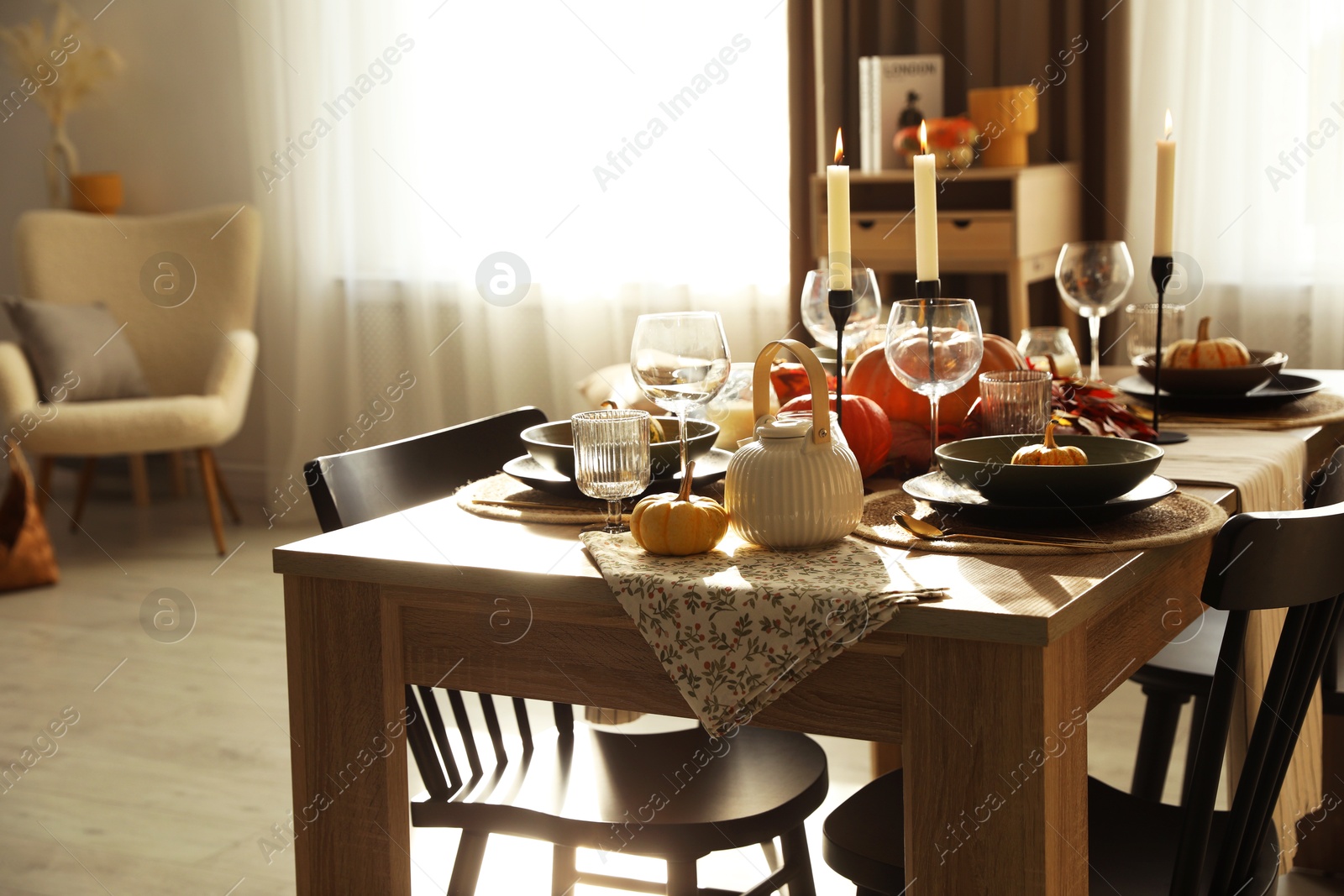 Photo of Stylish table setting with beautiful autumn decor in dining room