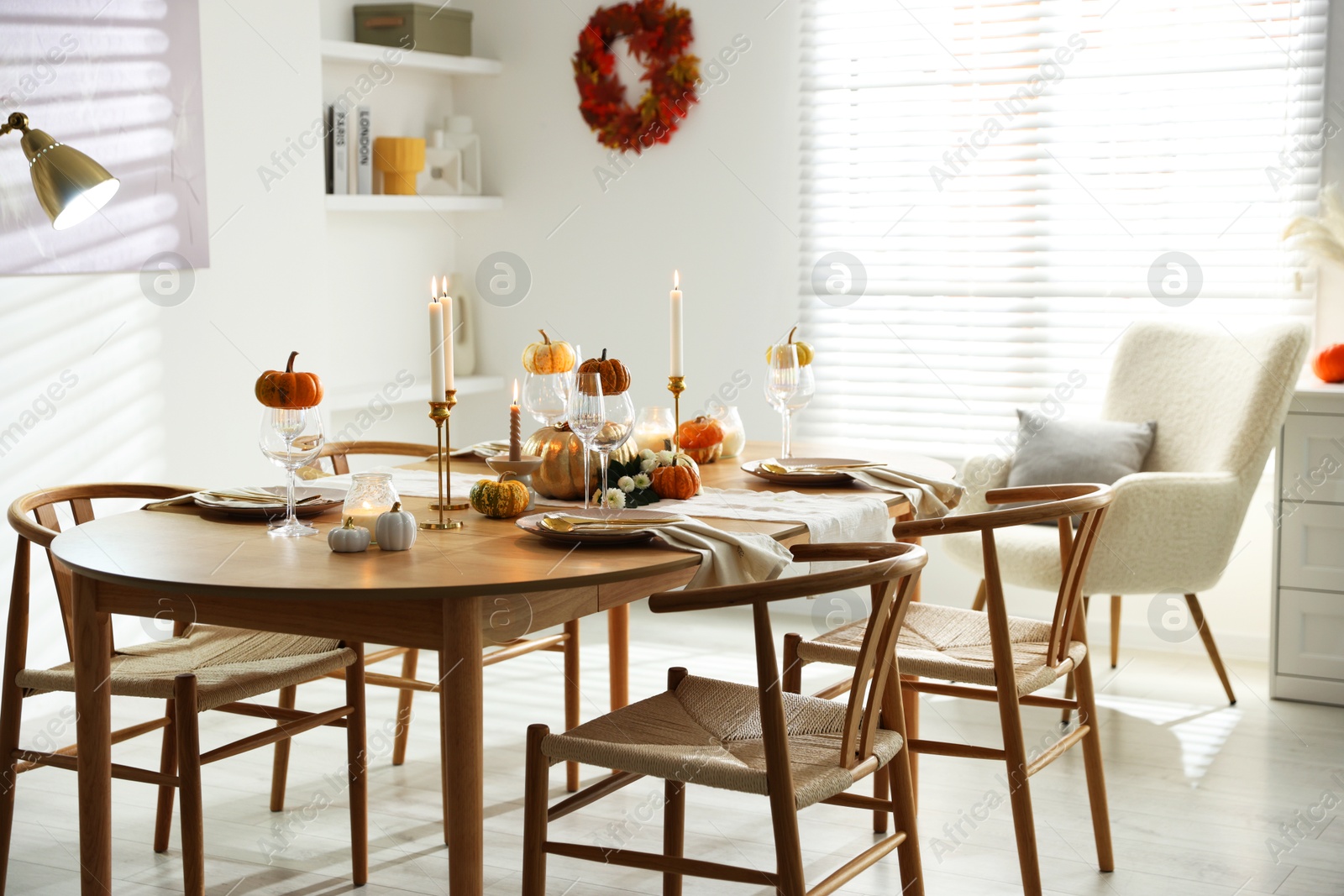 Photo of Stylish dining room with beautiful table setting and autumn decor