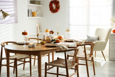 Photo of Stylish dining room with beautiful table setting and autumn decor