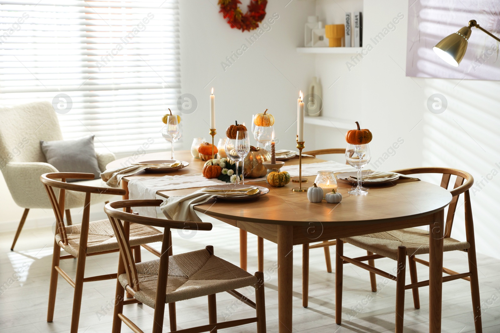 Photo of Stylish dining room with beautiful table setting and autumn decor