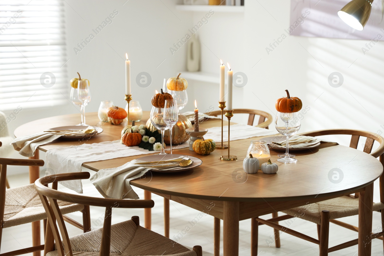 Photo of Stylish dining room with beautiful table setting and autumn decor