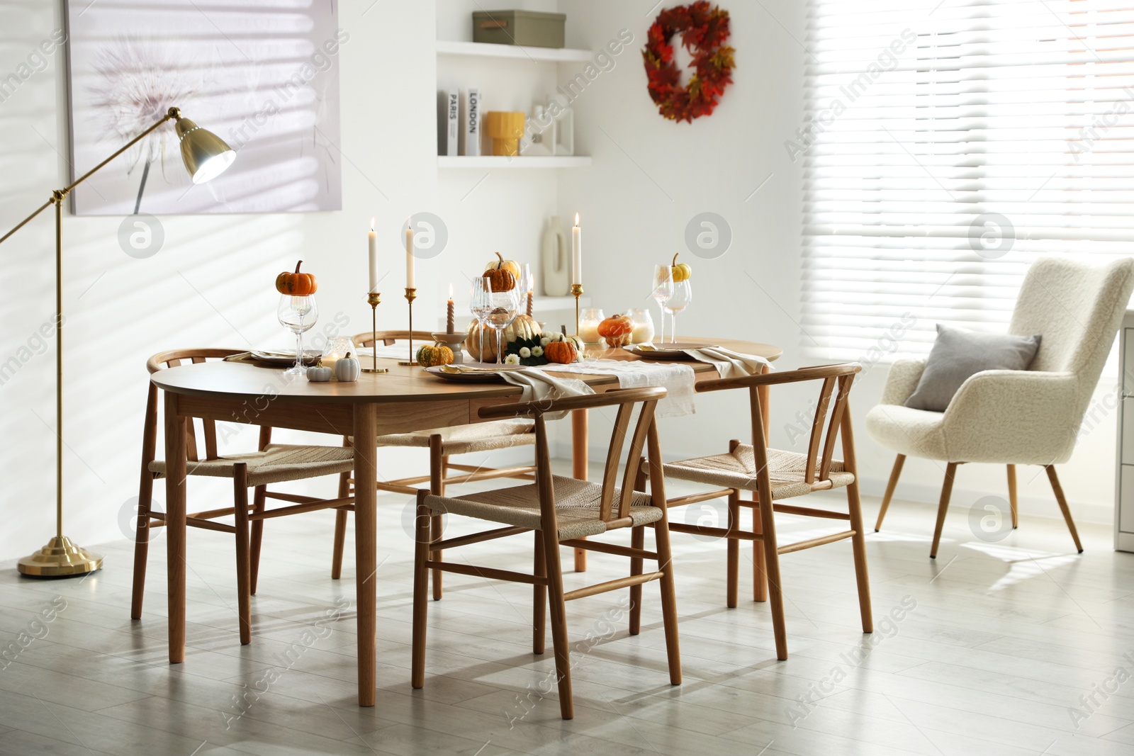 Photo of Stylish dining room with beautiful table setting and autumn decor