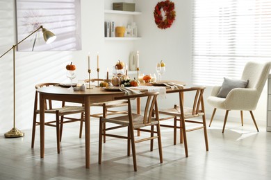 Stylish dining room with beautiful table setting and autumn decor