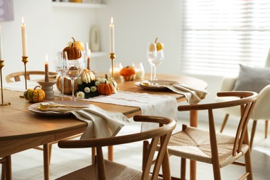 Photo of Stylish dining room with beautiful table setting and autumn decor