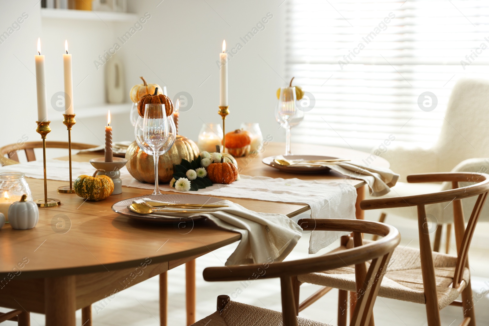 Photo of Stylish dining room with beautiful table setting and autumn decor