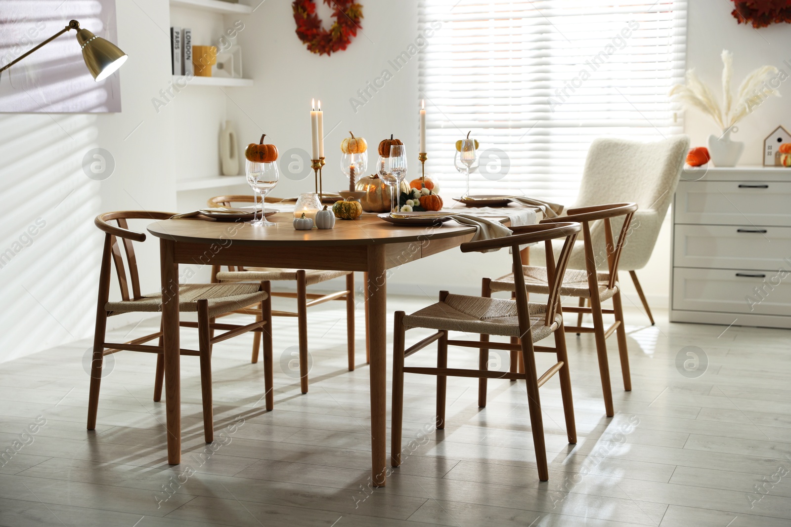 Photo of Stylish dining room with beautiful table setting and autumn decor