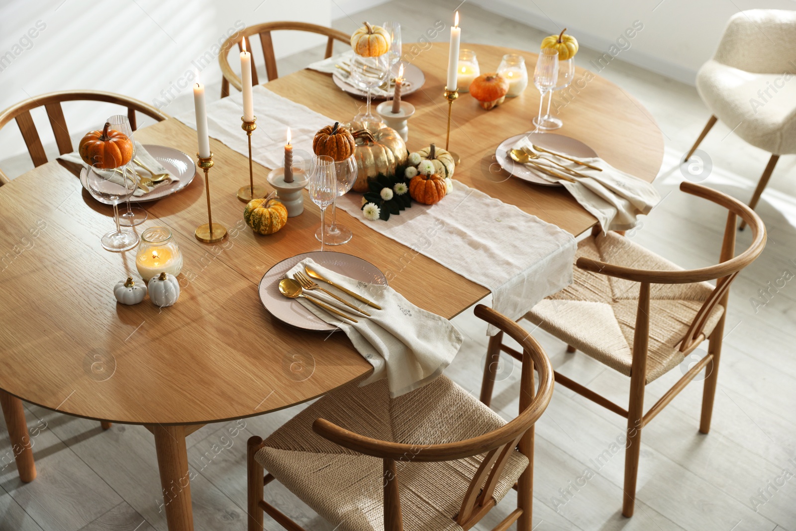 Photo of Stylish dining room with beautiful table setting and autumn decor