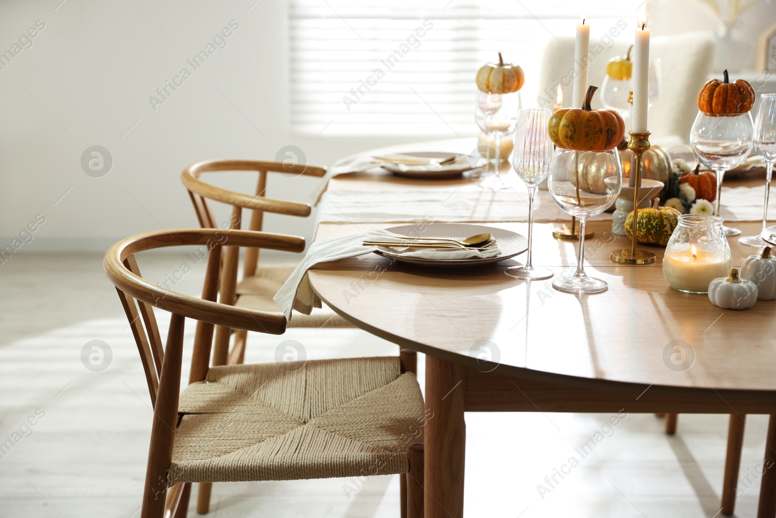 Photo of Stylish dining room with beautiful table setting and autumn decor