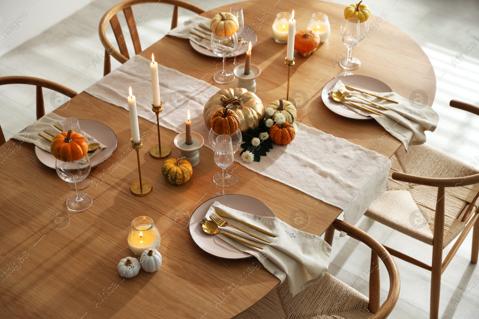 Photo of Stylish dining room with beautiful table setting and autumn decor