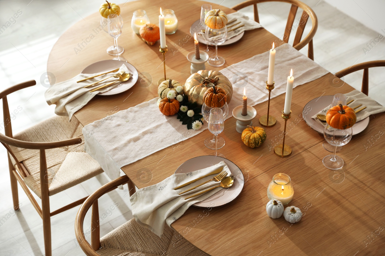 Photo of Stylish dining room with beautiful table setting and autumn decor