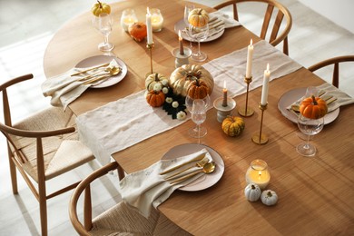 Stylish dining room with beautiful table setting and autumn decor