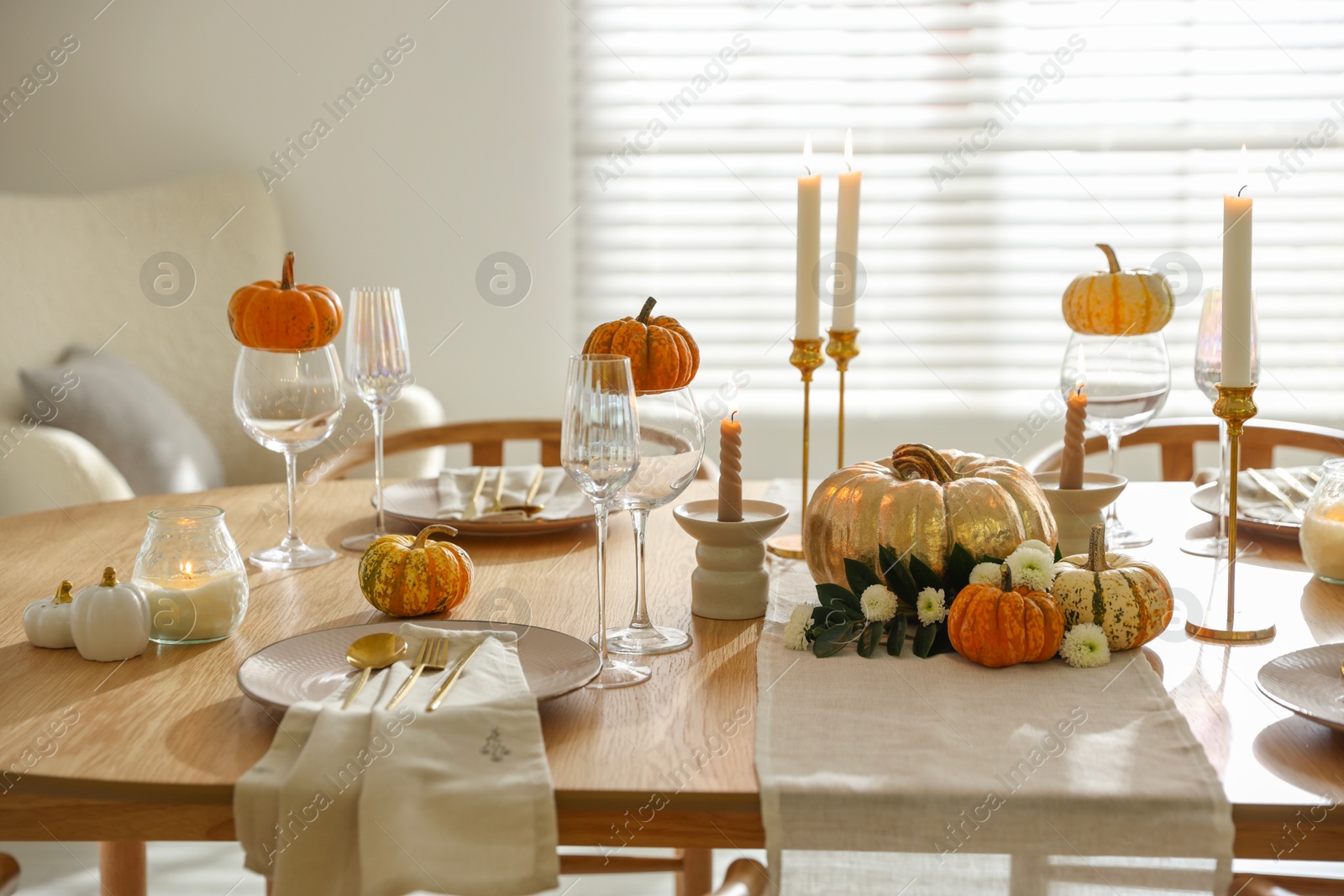 Photo of Stylish dining room with beautiful table setting and autumn decor