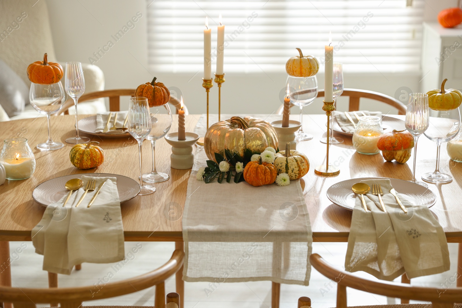 Photo of Stylish dining room with beautiful table setting and autumn decor