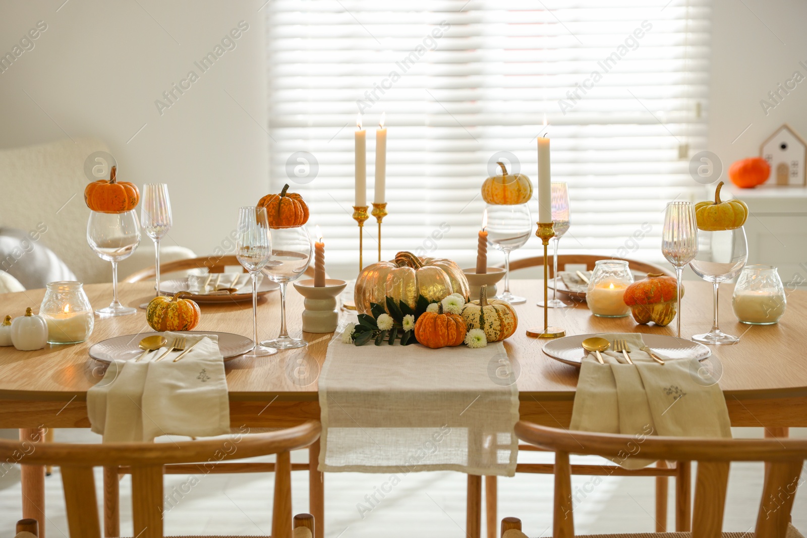 Photo of Stylish dining room with beautiful table setting and autumn decor