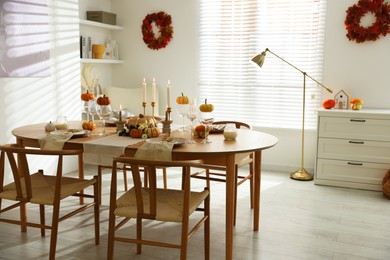 Photo of Stylish dining room with beautiful table setting and autumn decor