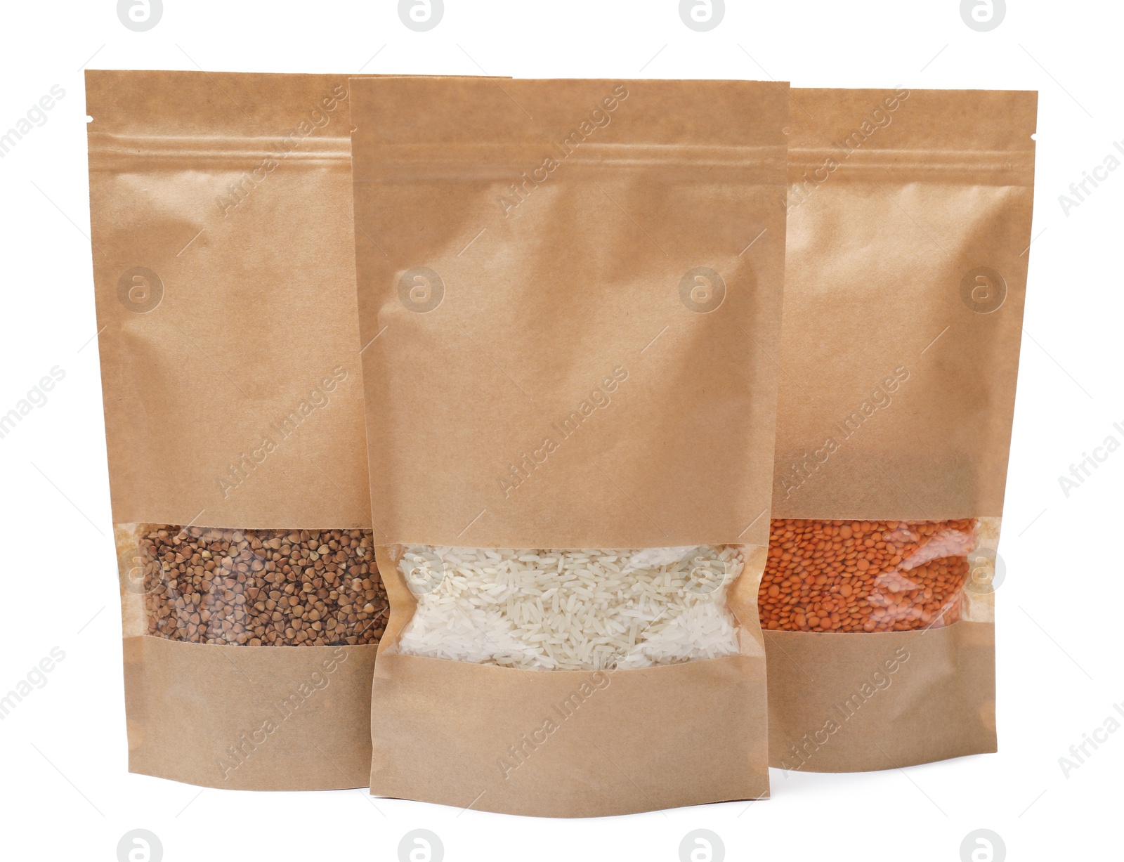 Photo of Paper pouch bags with buckwheat, rice and lentil isolated on white