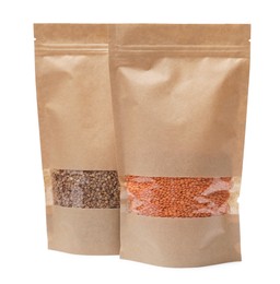 Photo of Paper pouch bags with buckwheat and lentil isolated on white