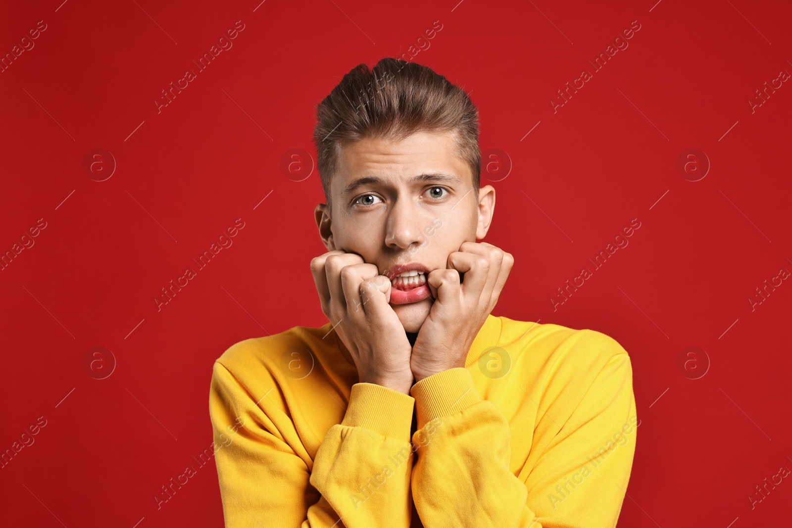 Photo of Emotional student having stress before exam on red background