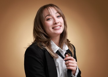 Photo of Attractive woman with stylish haircut on brown gradient background