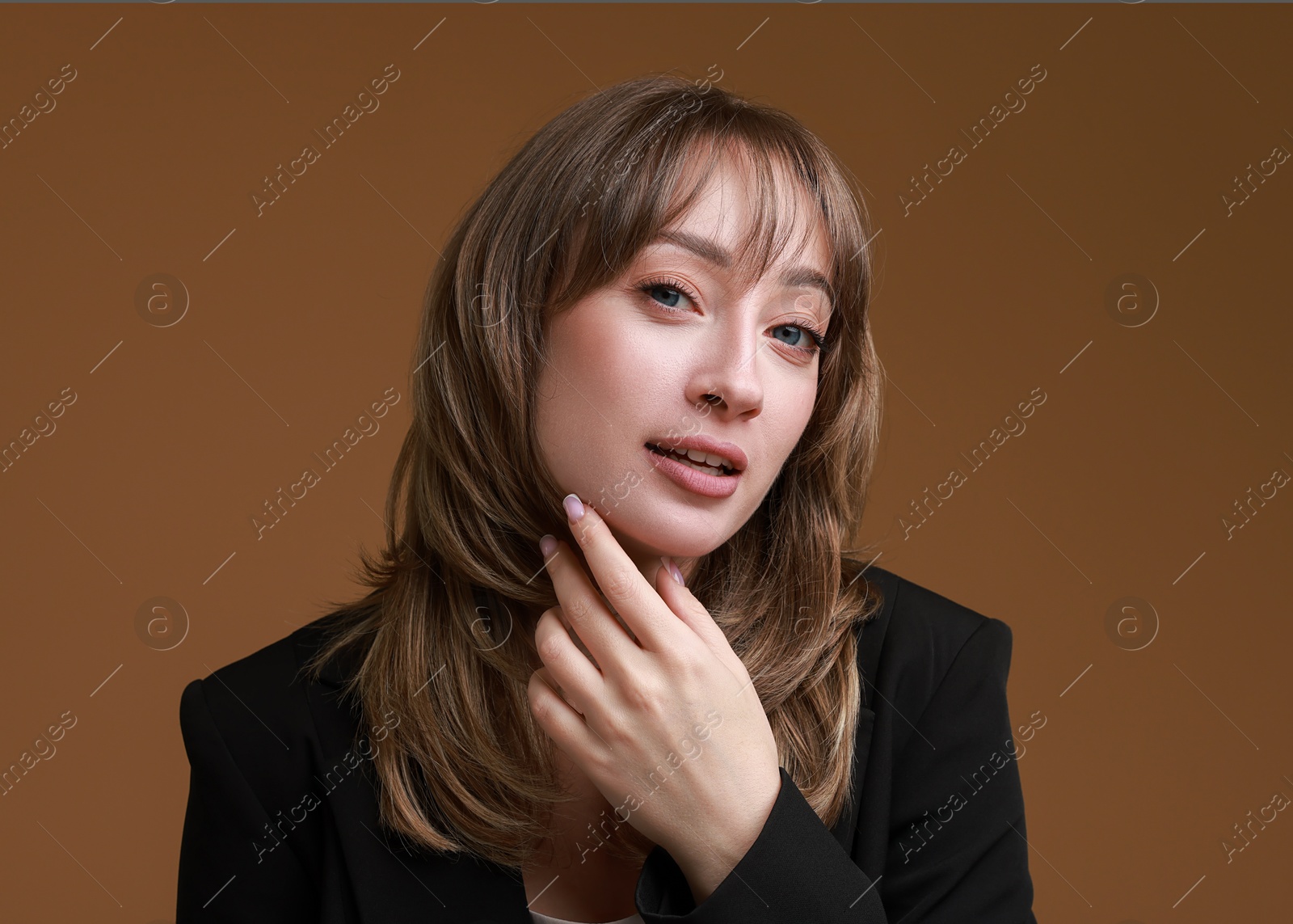 Photo of Attractive woman with stylish haircut on brown background