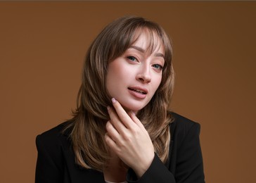 Photo of Attractive woman with stylish haircut on brown background