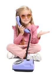 Photo of Cute little girl with telephone on white background