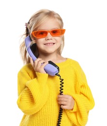 Cute little girl with handset of telephone on white background