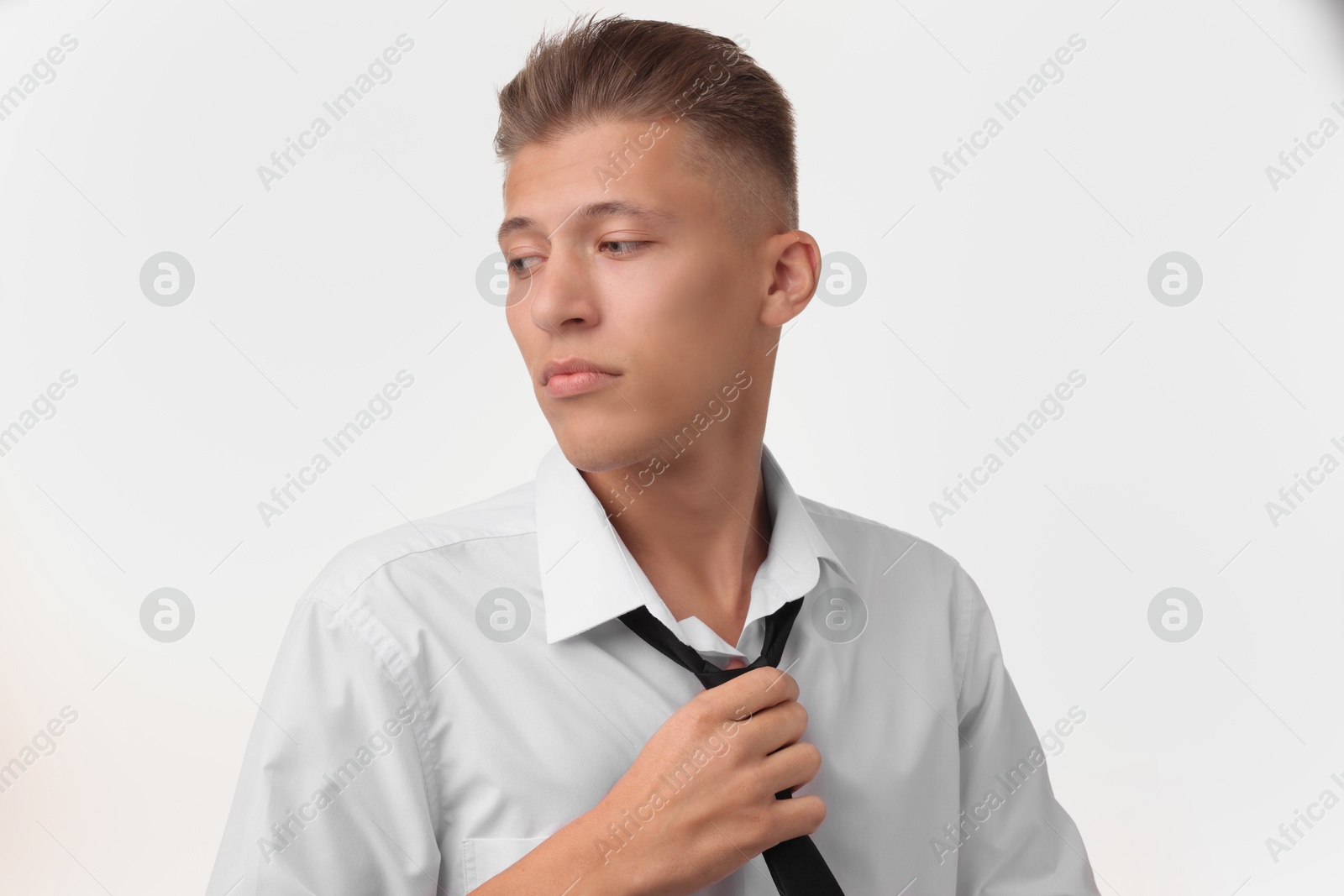 Photo of Confident young man with stylish haircut on white background