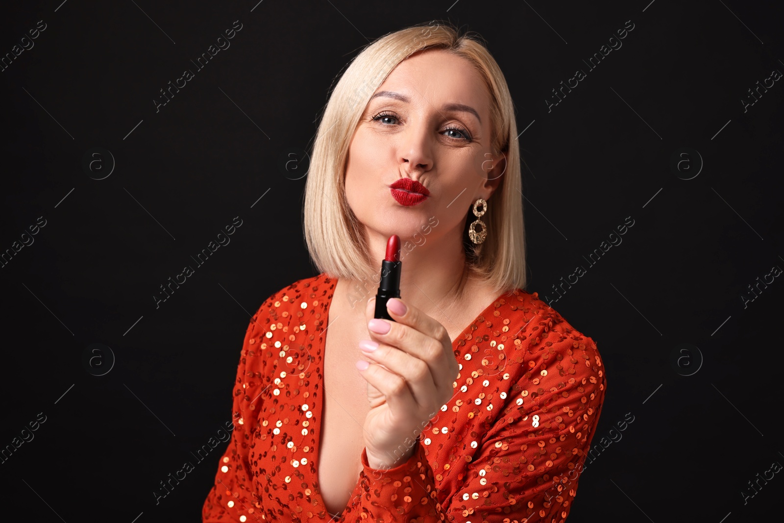 Photo of Woman with red lipstick on black background