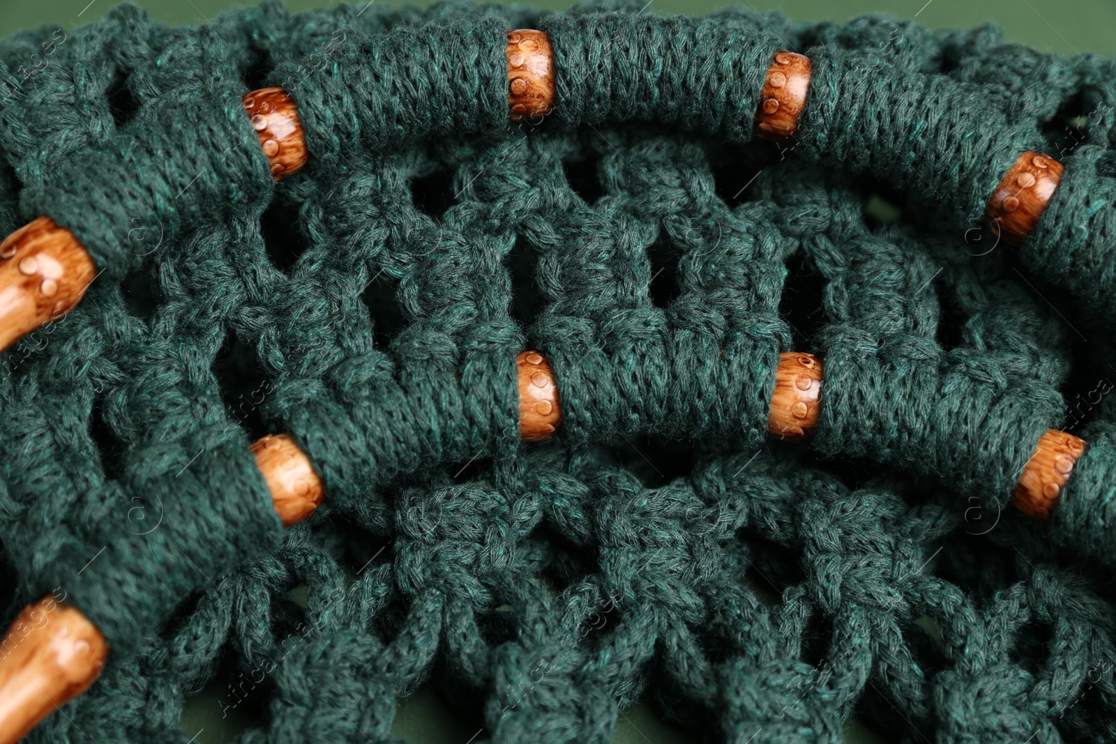 Photo of Macrame shopping bag with wooden handles as background, closeup