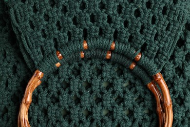 Photo of Macrame shopping bag with wooden handles as background, top view