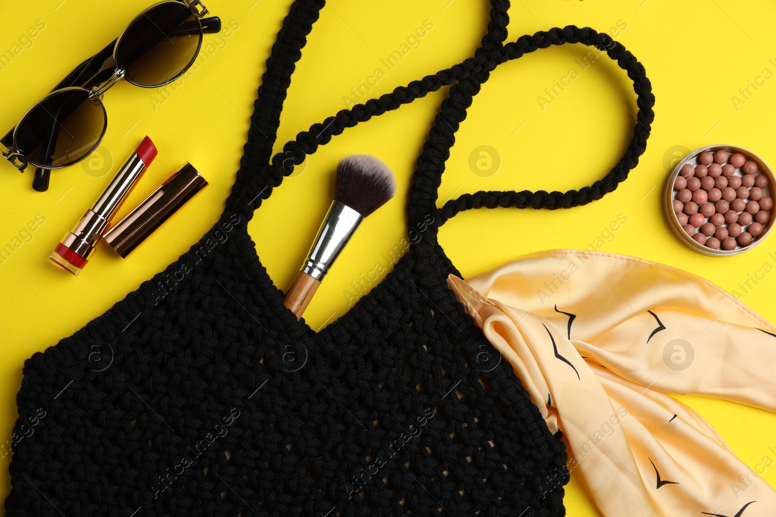 Photo of Flat lay composition with macrame shopping bag and makeup products on yellow background