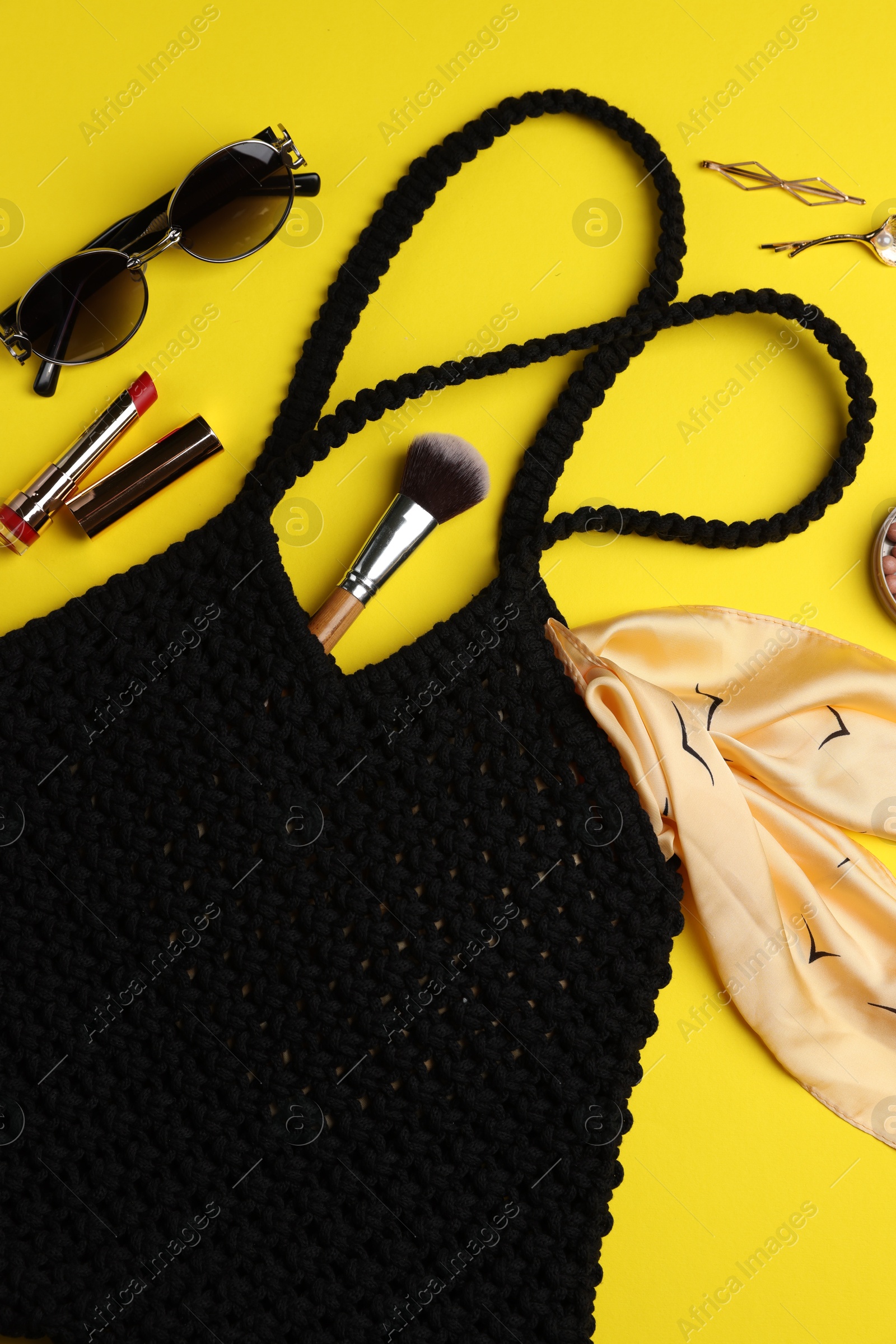 Photo of Flat lay composition with macrame shopping bag and makeup products on yellow background