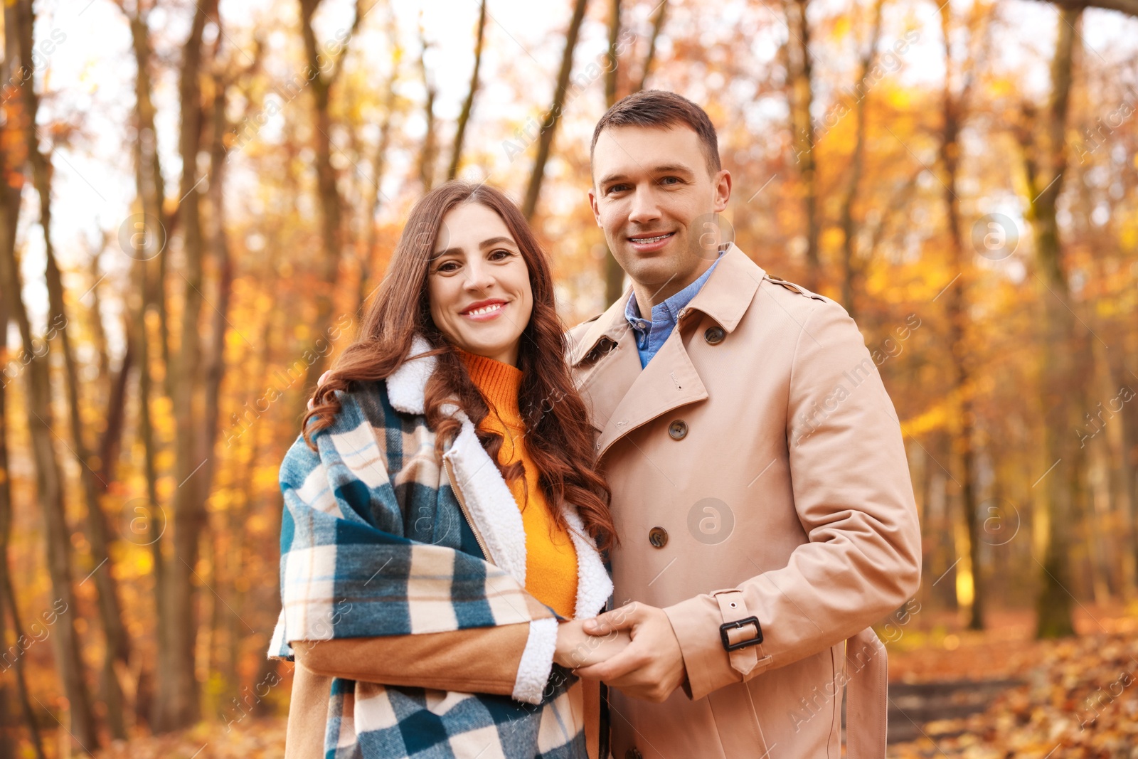 Photo of Happy couple spending time together in autumn park