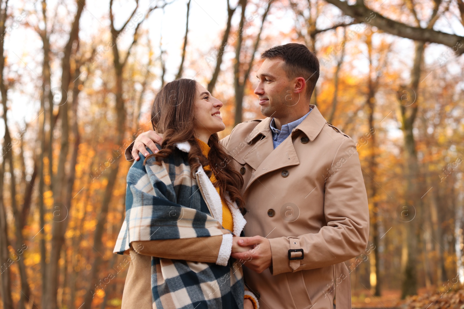 Photo of Happy couple spending time together in autumn park