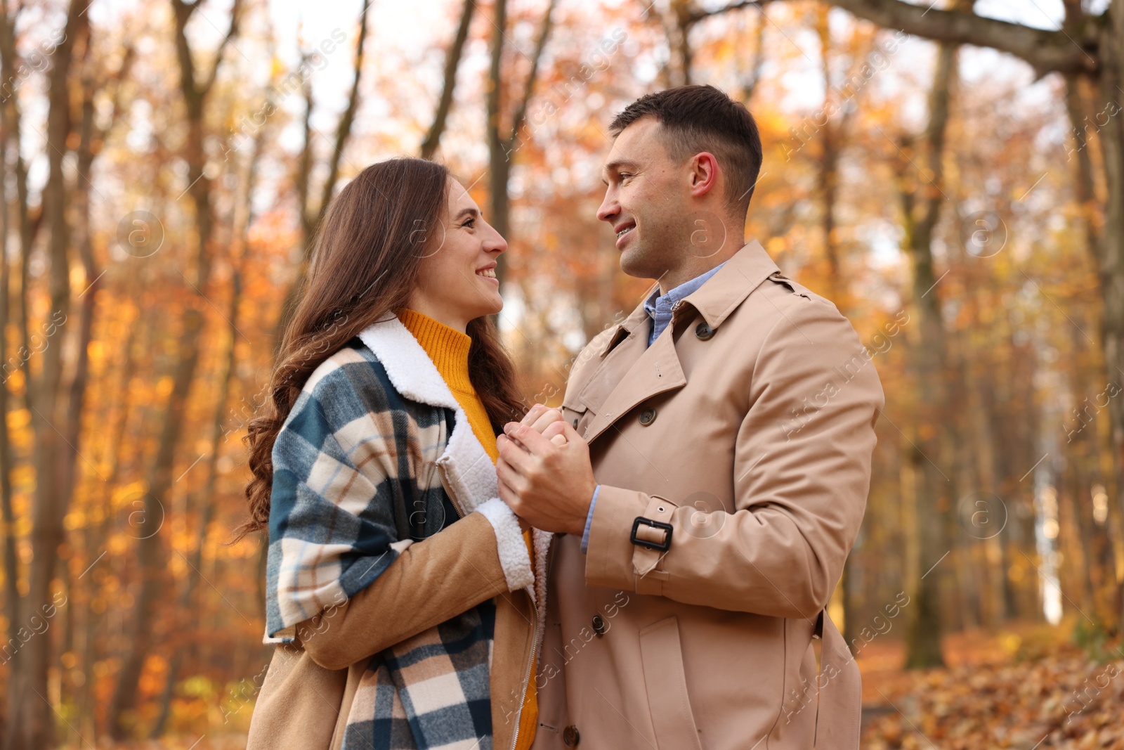 Photo of Happy couple spending time together in autumn park