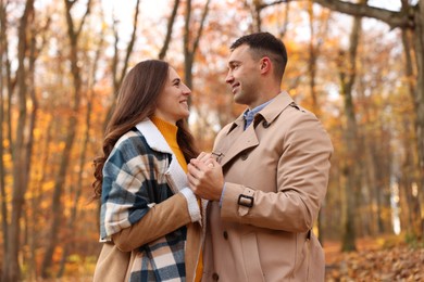 Photo of Happy couple spending time together in autumn park