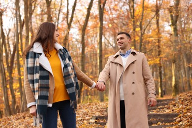 Photo of Happy couple spending time together in autumn park