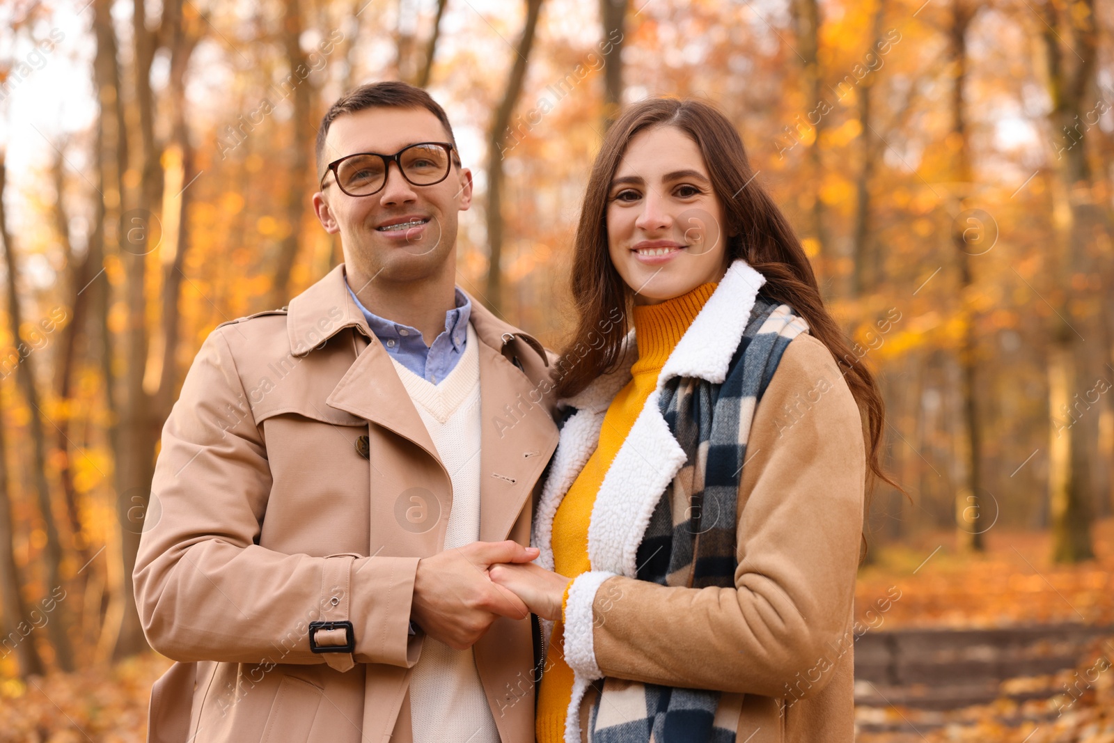 Photo of Happy couple spending time together in autumn park