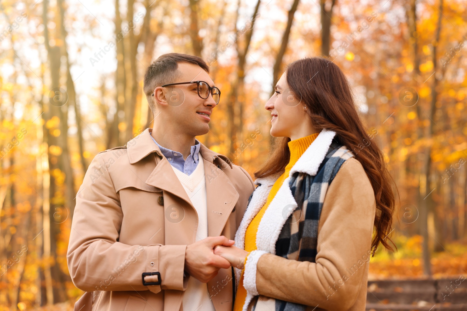 Photo of Happy couple spending time together in autumn park