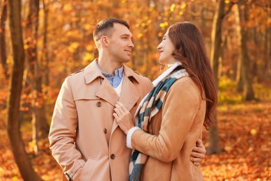 Happy couple spending time together in autumn park