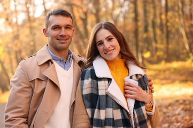 Photo of Happy couple spending time together in autumn park